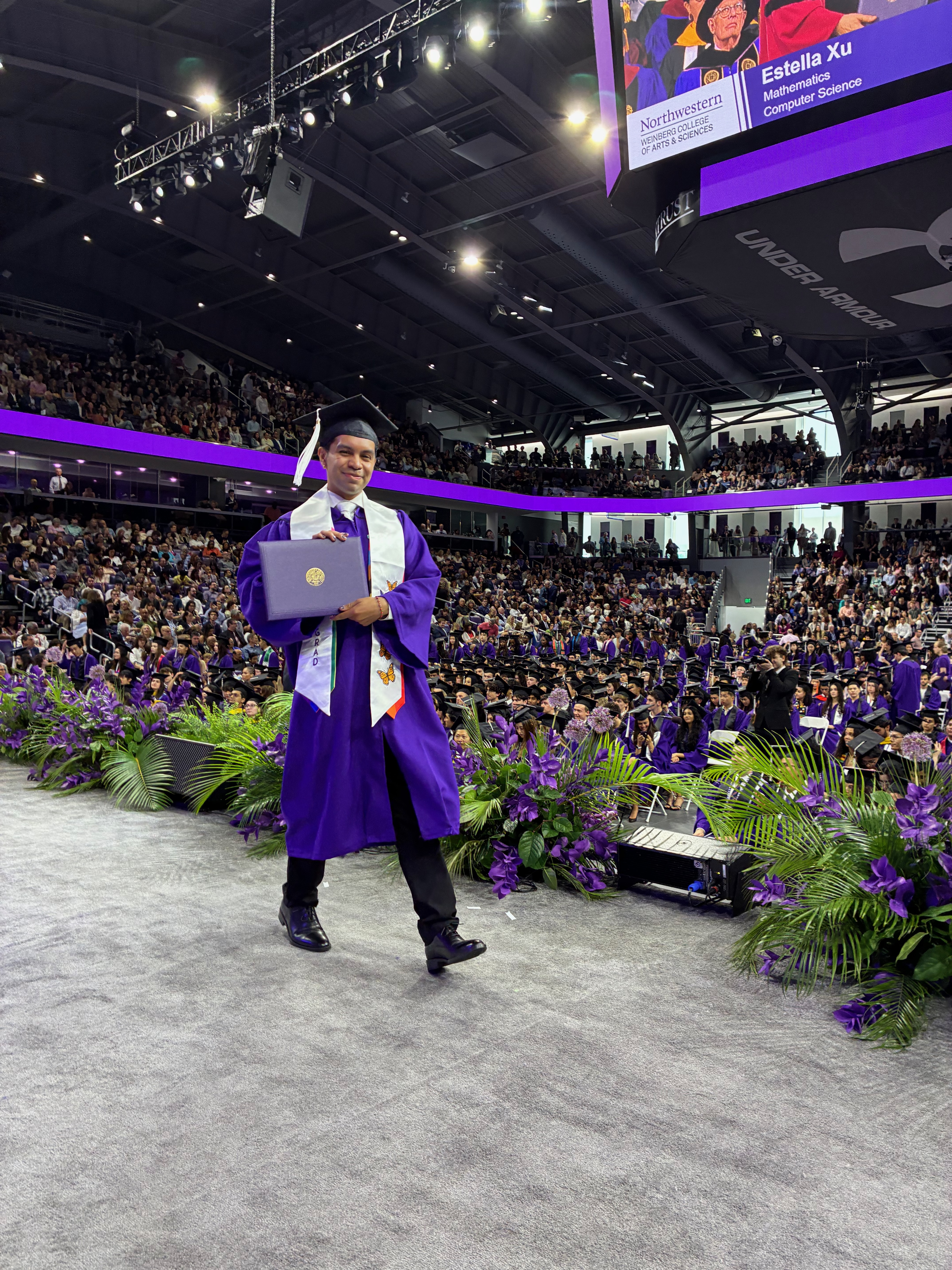 Diego Portillo walking across stage with diploma